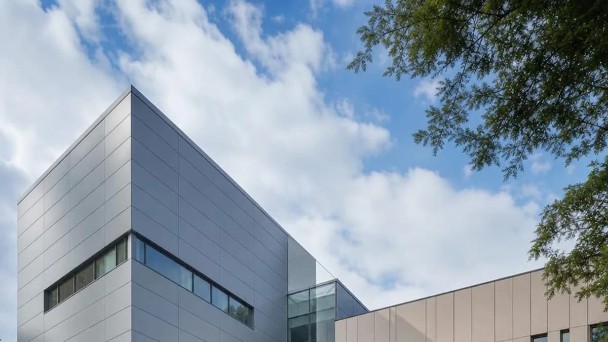 Corporate headquarters with linear aluminum cladding across a contemporary commercial facade